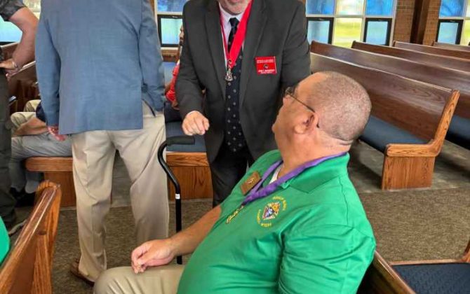 District Deputy John McCatney congratulations new GK Mike Bell at the installation at St. Jude's.
